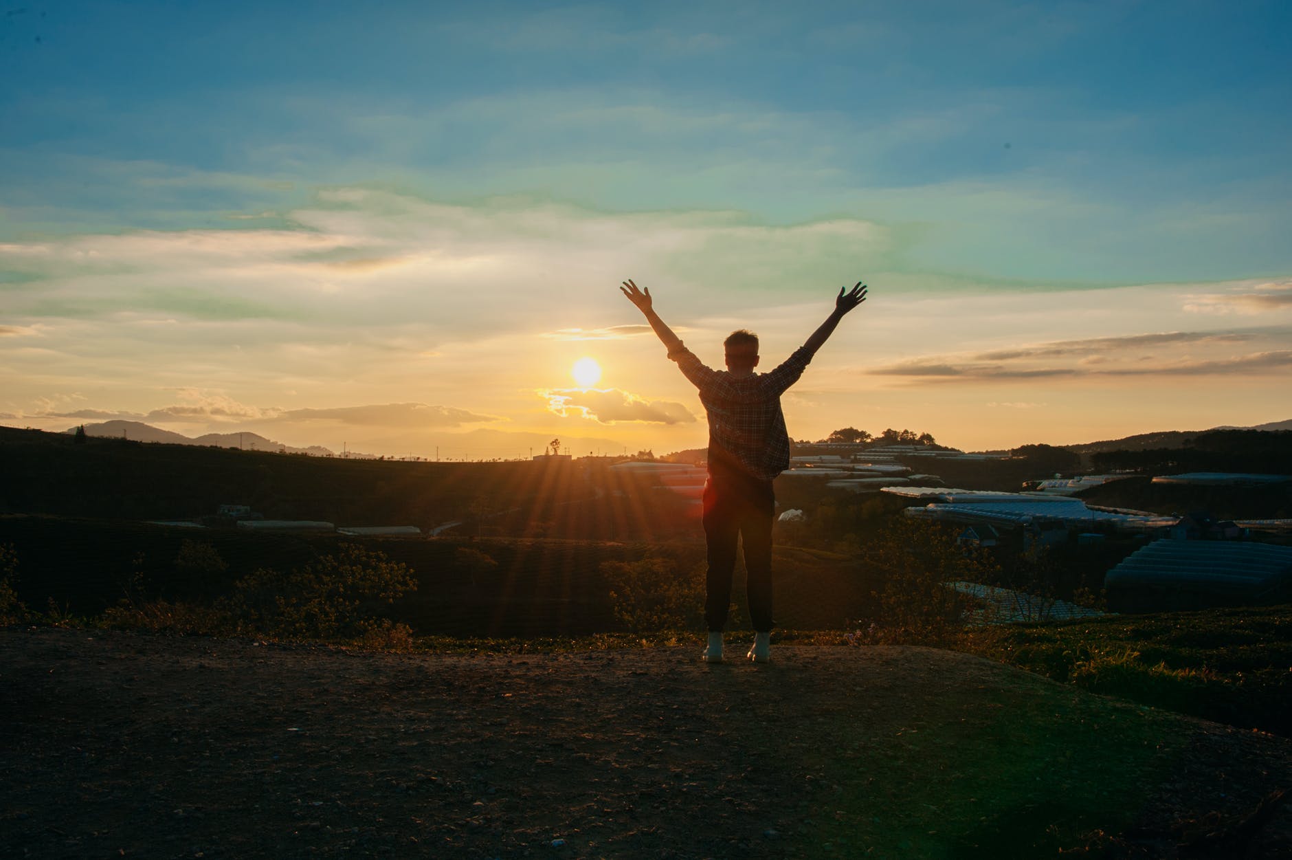 photography of man raising both hands