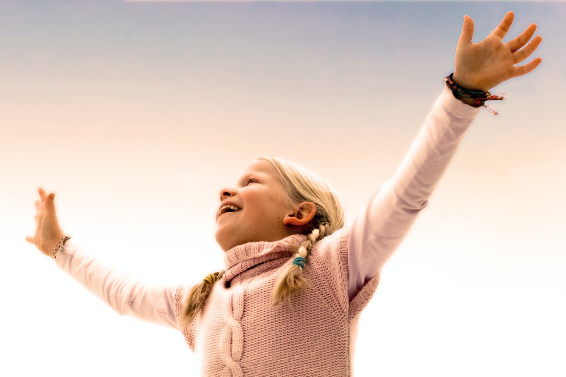 blonde haired girl wearing pink sweater