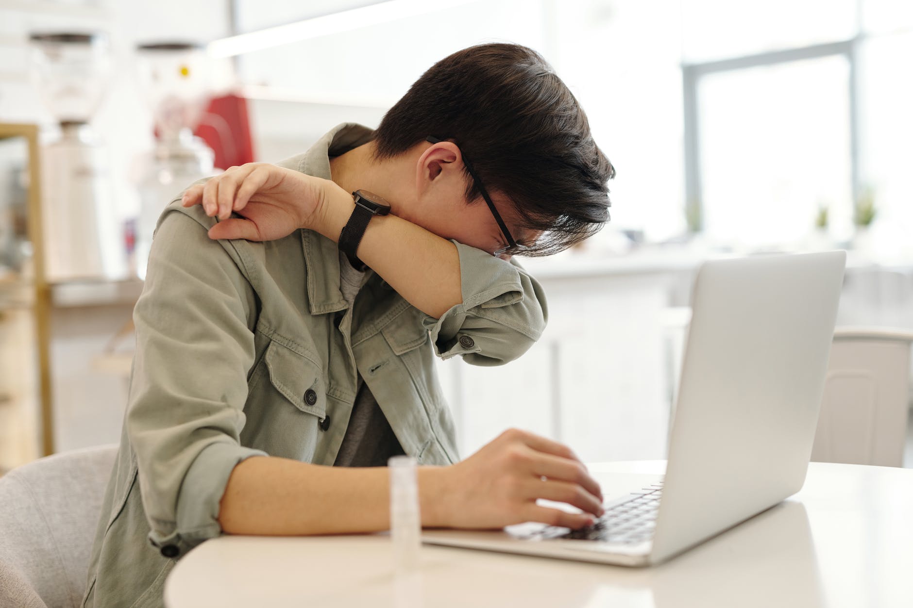 a sick man covering his mouth