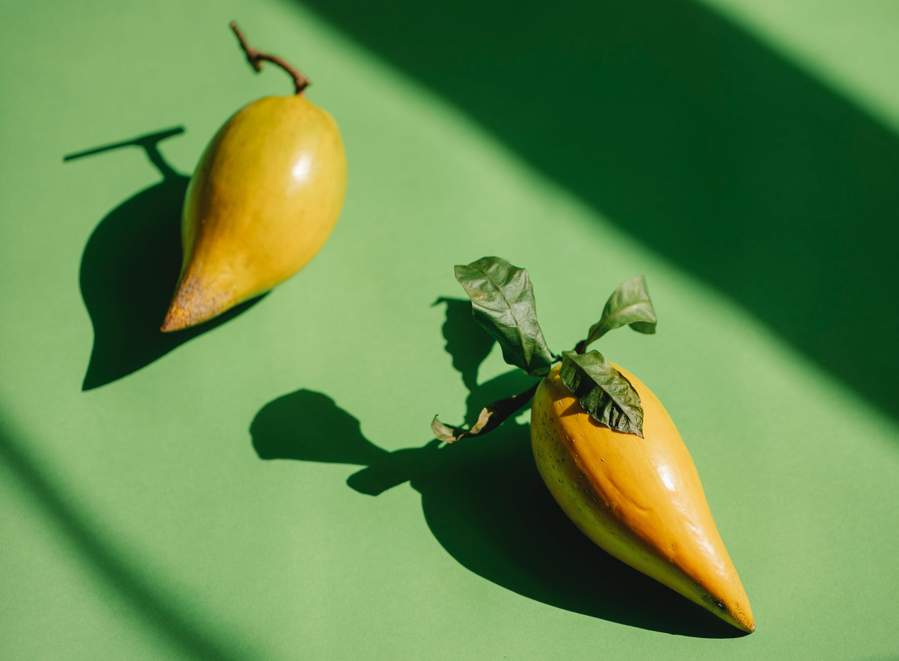 ripe whole pouteria campechiana fruits placed on green surface