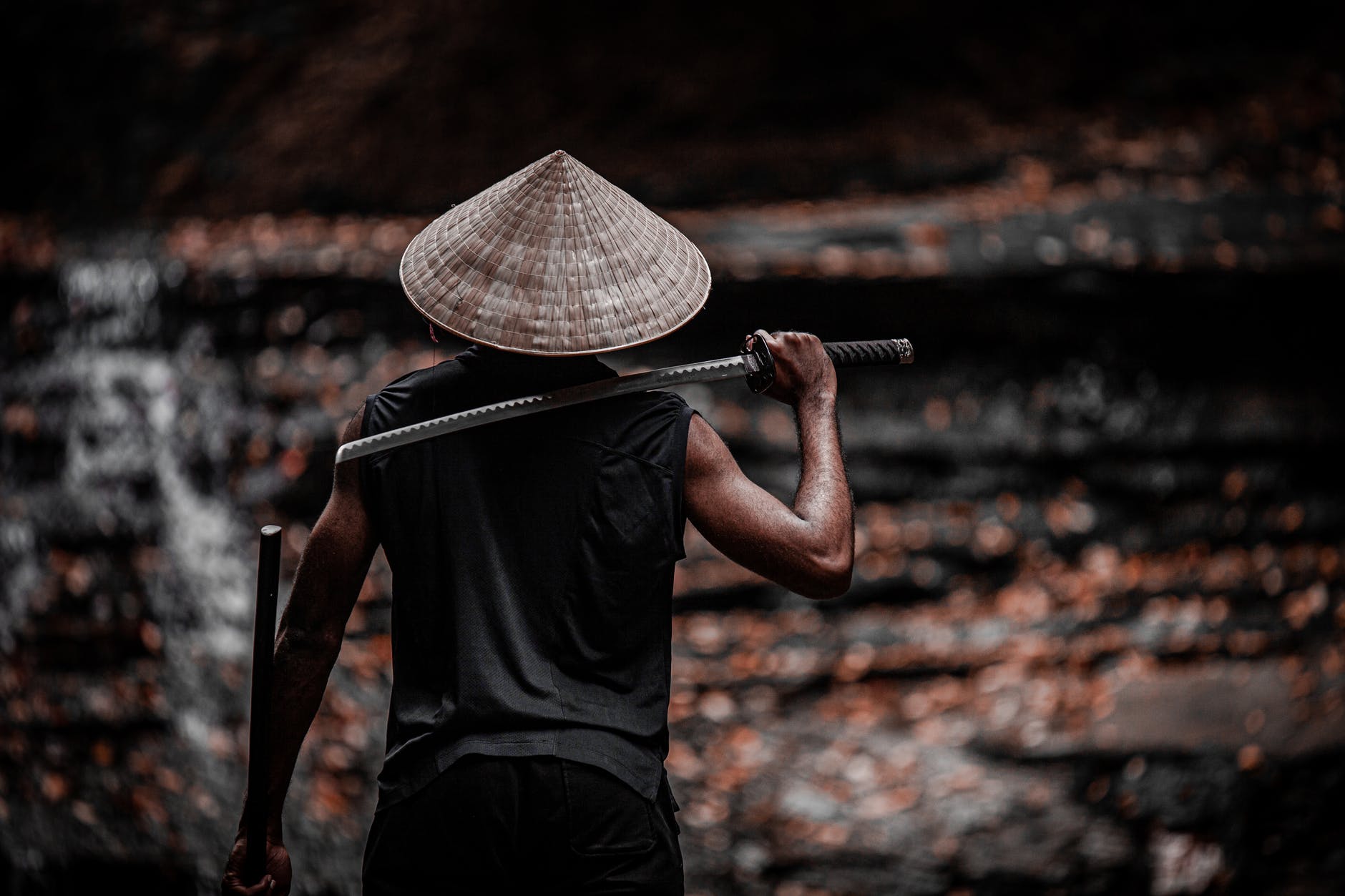 man holding sword on his back