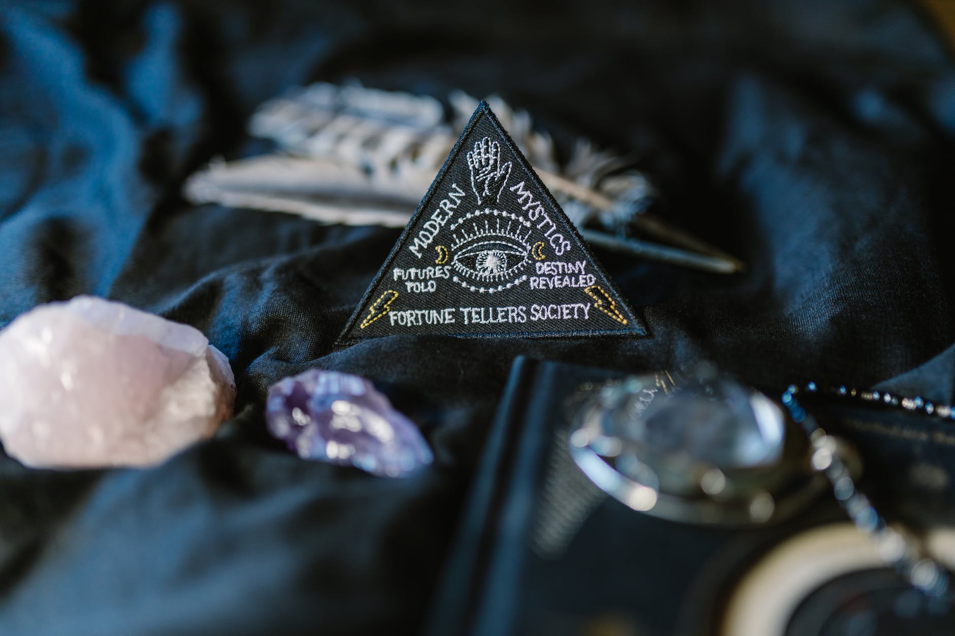 a triangle sign surrounded by crystals on a black surface