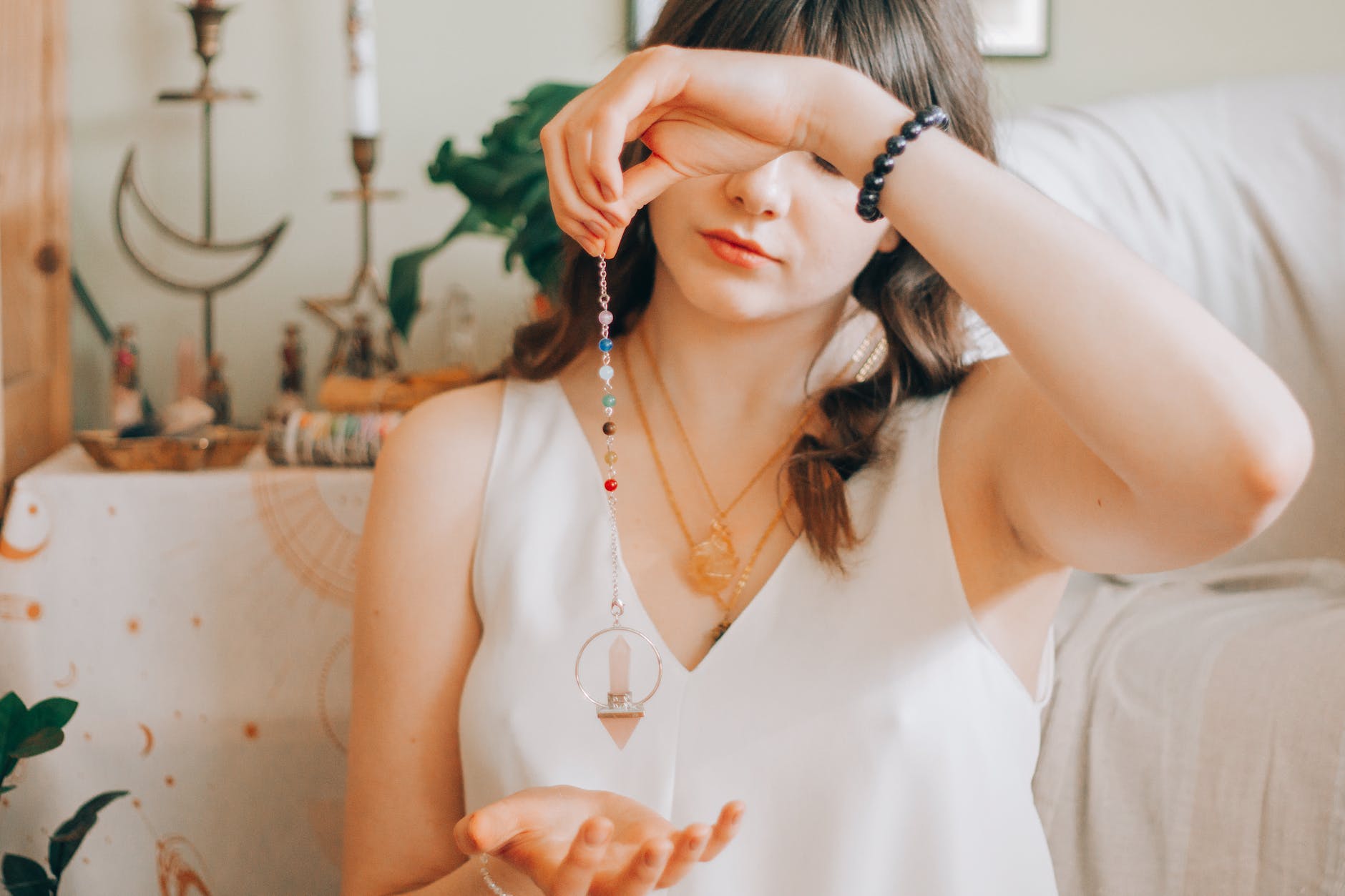 woman telling fortune with silver pendant