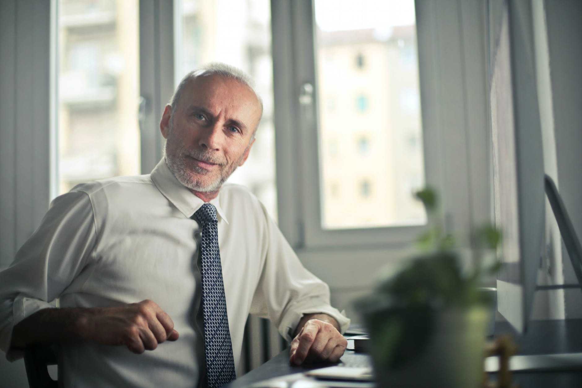 man sitting on chair beside table