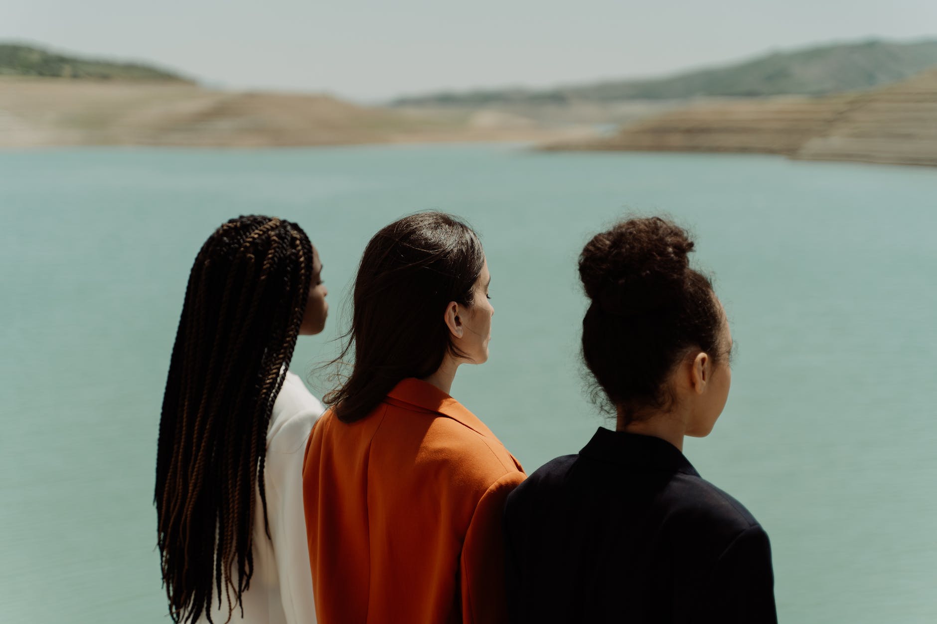 women standing near the lake