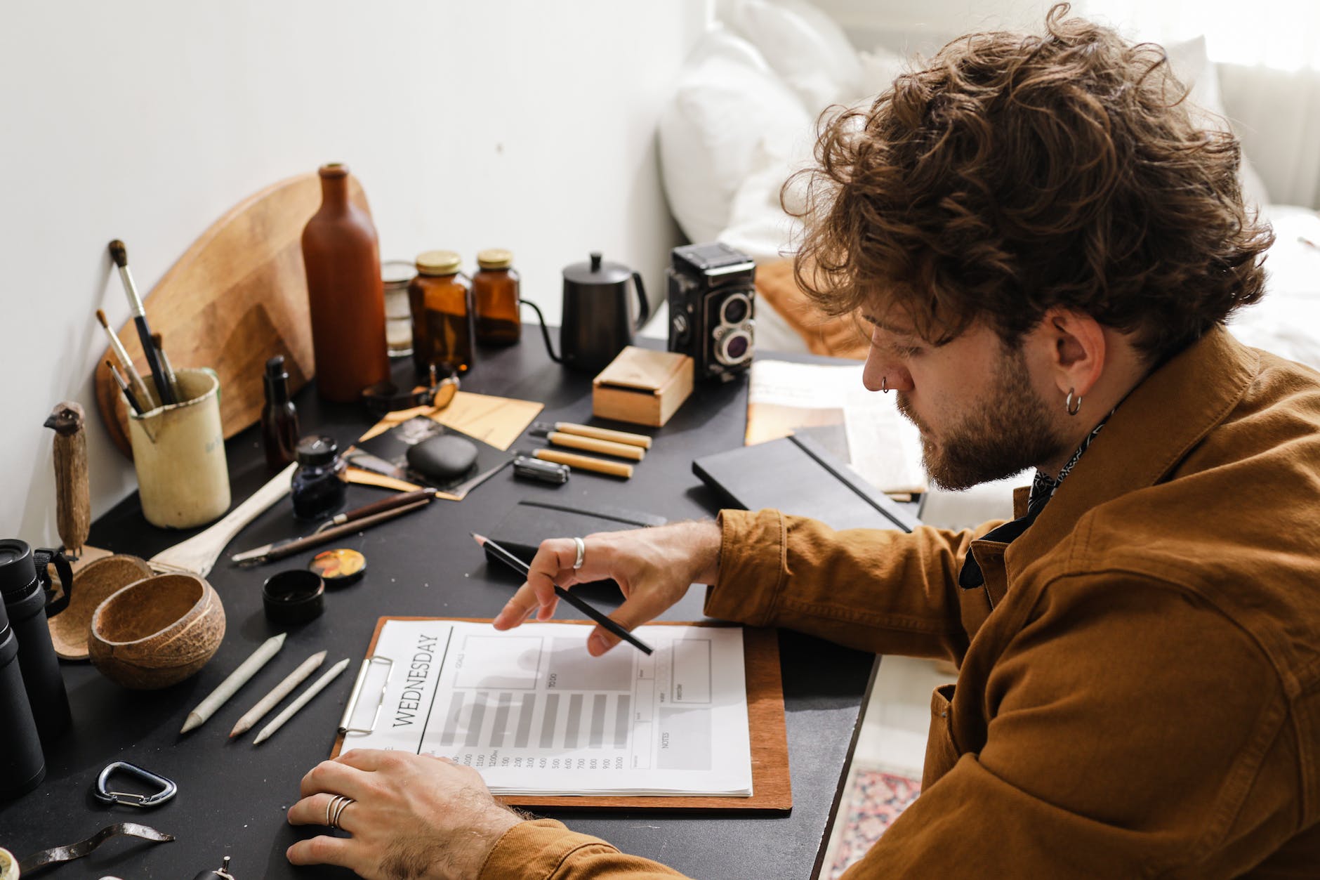 man with task planner on desk